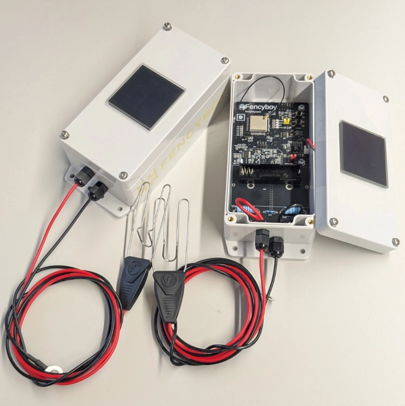 Two Fencyboy solar units. One of them opened to show internal electronics.